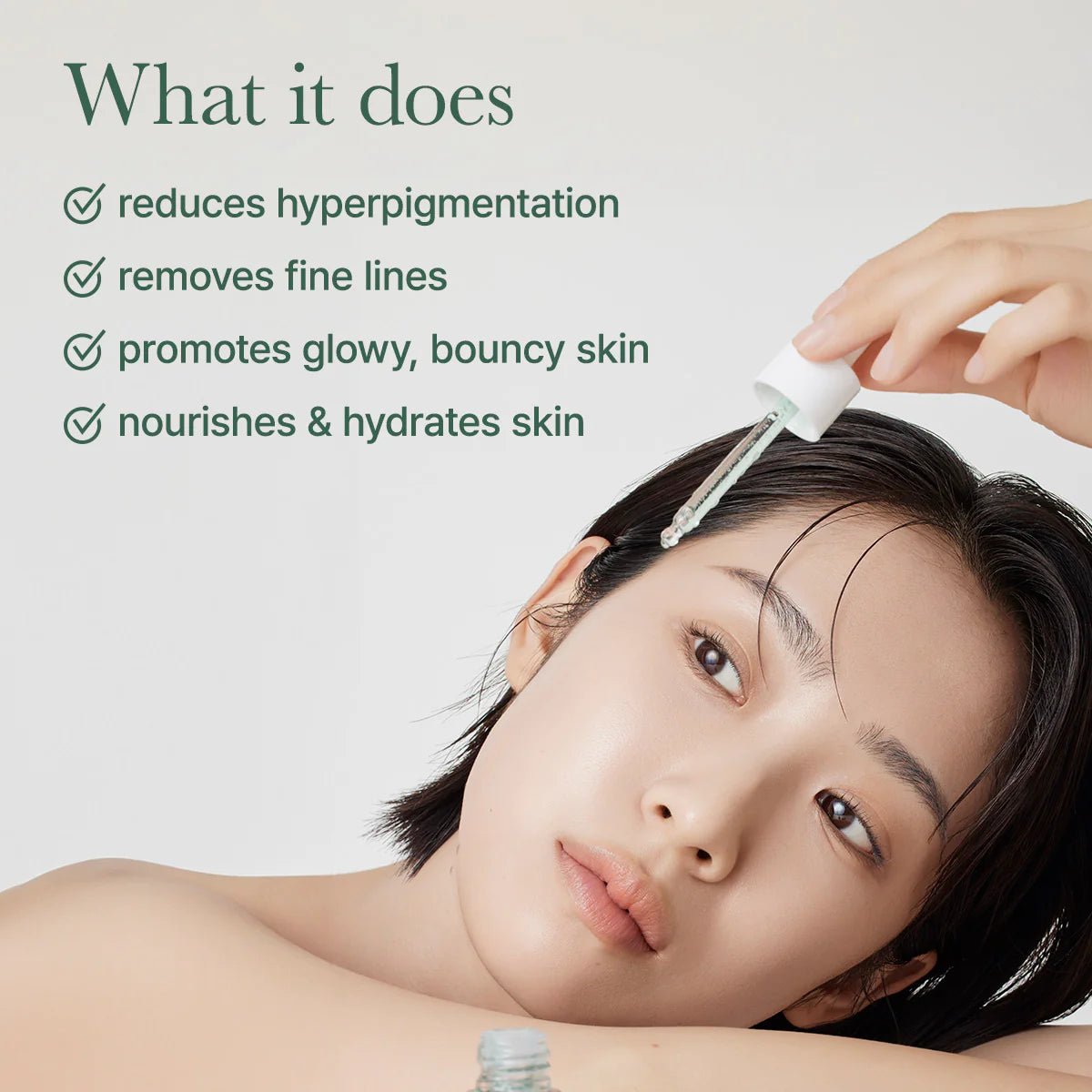 Woman applying arencia holy hyssop serum product with text about its benefits on a light background.