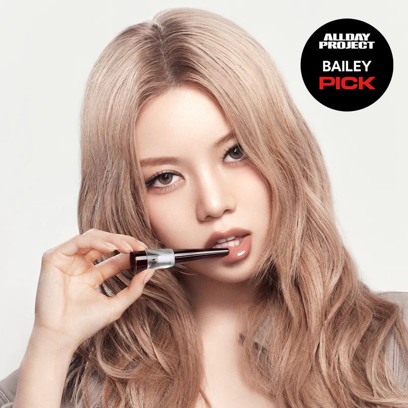 Young Korean woman putting on lip plumper, featuring the “All Day Project Bailey Pick” logo.