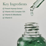 Green dropper bottle with a list of key ingredients on a light gray background