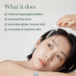 Woman applying arencia holy hyssop serum product with text about its benefits on a light background.