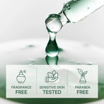 Glass bottle with a droplet of liquid on a reflective surface, featuring icons and text about product attributes.