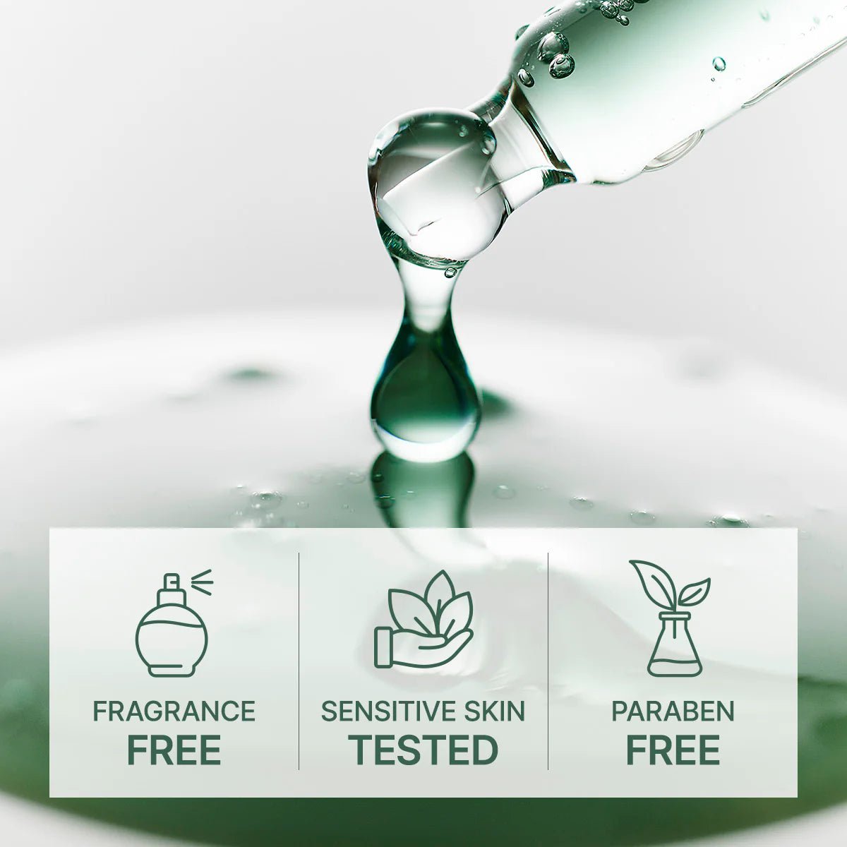 Glass bottle with a droplet of liquid on a reflective surface, featuring icons and text about product attributes.