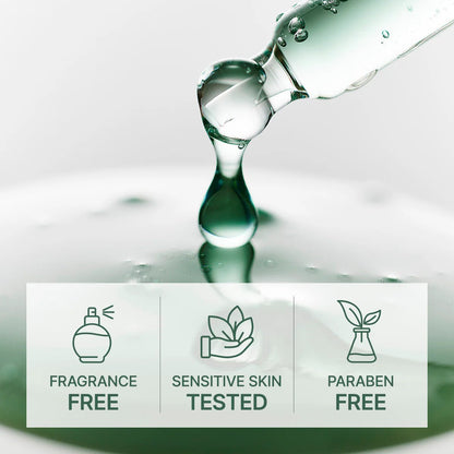 Glass bottle with a droplet of liquid on a reflective surface, featuring icons and text about product attributes.