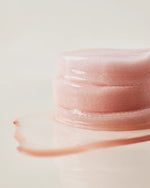 Close-up of a stack of moisture-soaked House of Hur essence pads.