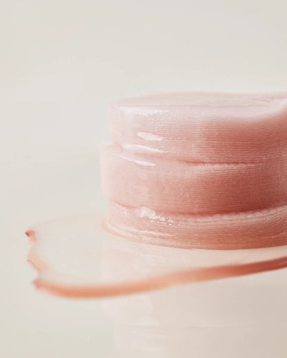 Close-up of a stack of moisture-soaked House of Hur essence pads.