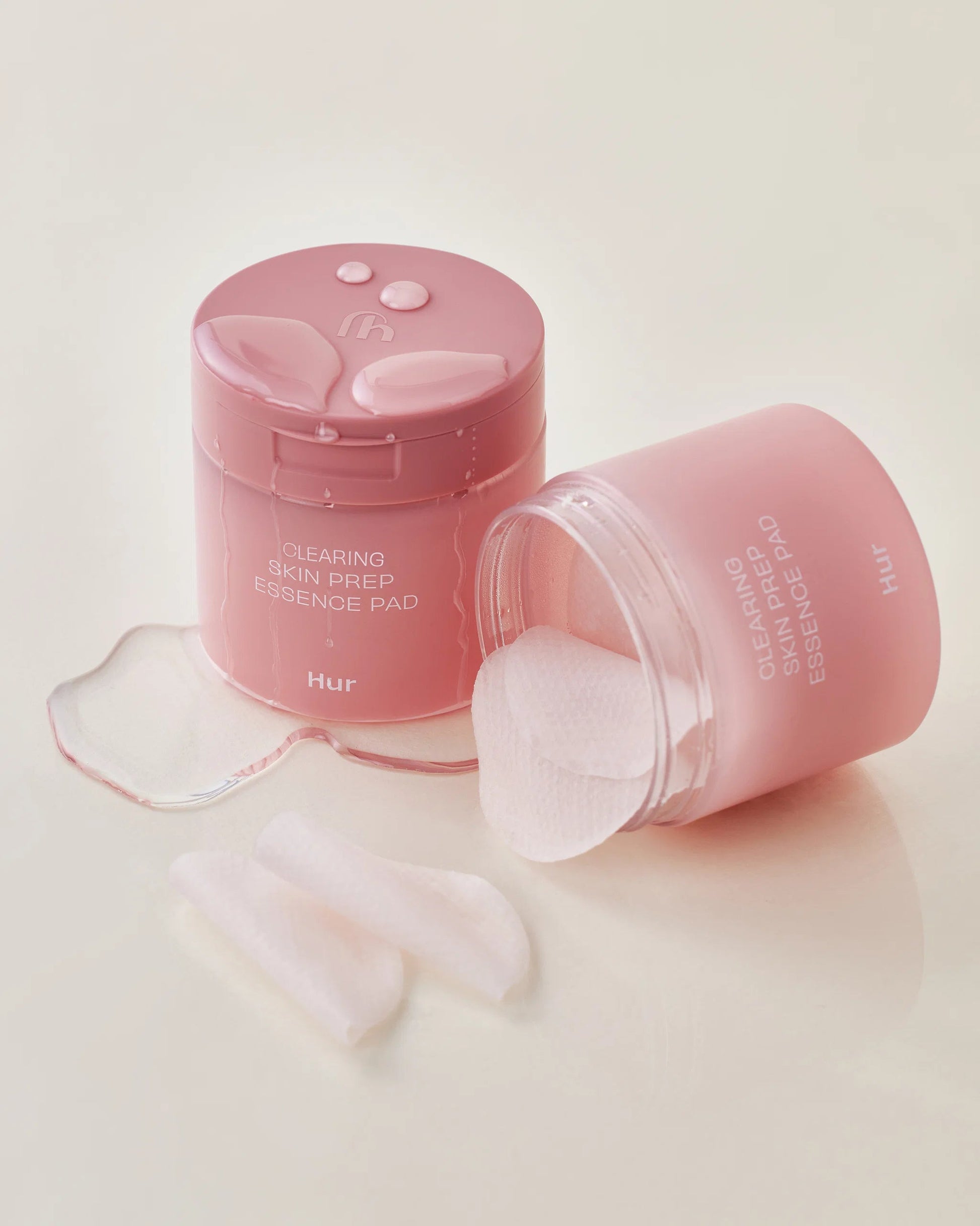 Pink jar of House of Hur Clearing Skin Prep Essence Pads with spilled essence.