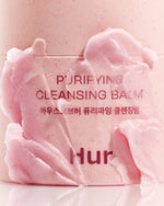 Macro shot of the pink sorbet texture of House of Hur Cleansing Balm showing its soft, spreadable consistency.