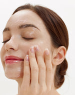 Close-up of a woman massaging House of Hur Purifying Cleansing Balm onto her face for a gentle deep cleanse.