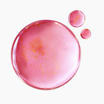 Close-up of Purito TXA serum texture showing pink gel and suspended yellow retinal capsules.