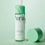 Purito Wonder Releaf Centella Toner bottle with a clear, hydrating liquid texture pouring over the cap.