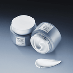 Two jars of Skin1004 Madagascar Centella Hyalu-Teca Firming Cream with a smooth cream swirl in front.