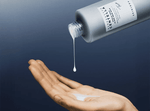 Person pouring Skin1004 Hyalu-Teca Glass Skin Milk into palm showing its smooth milky texture.